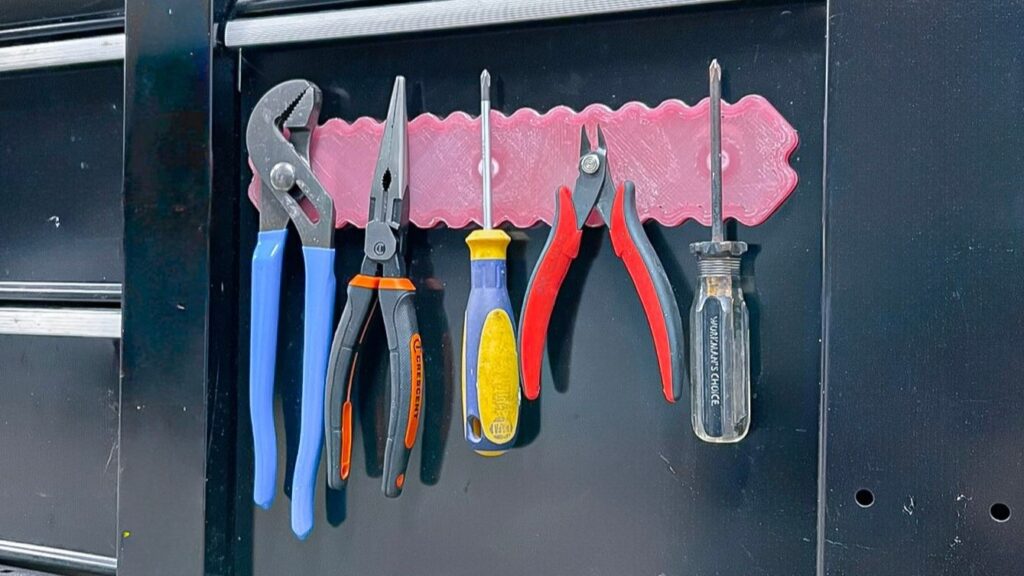 3d printed knife / tool holder attached on a workbench holding a bunch of different tools