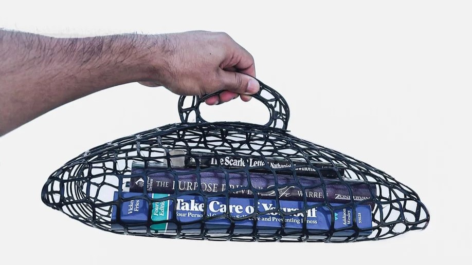 3D printed mesh bag holding 3 books